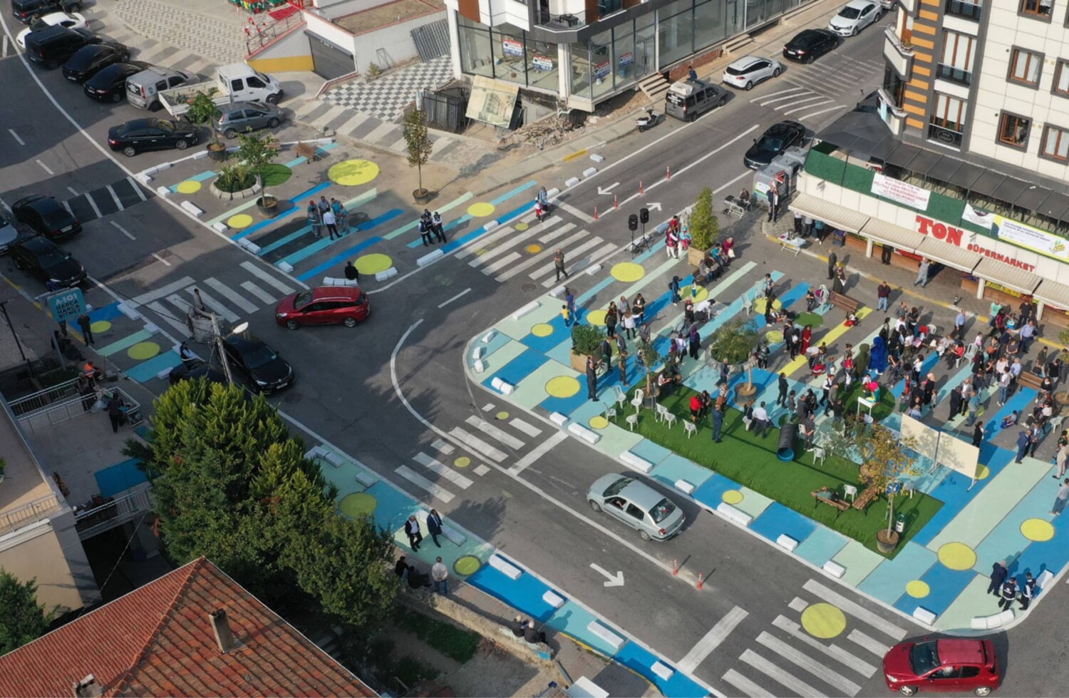 A colorful street with a park adjacent to it